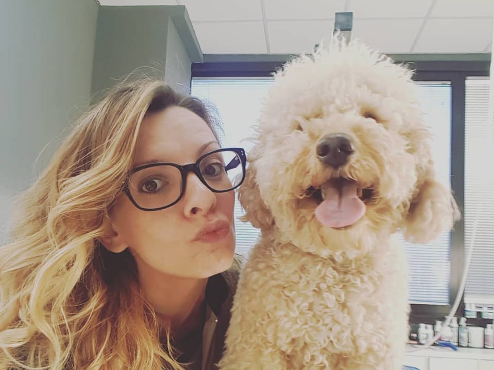 Gabriella, la zia Gabry, in sala di toelettatura accanto a un lagotto appena asciugato
